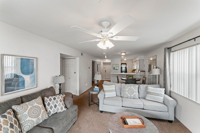 living room featuring light carpet and ceiling fan