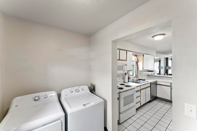 kitchen featuring light tile patterned floors, sink, white appliances, white cabinetry, and independent washer and dryer