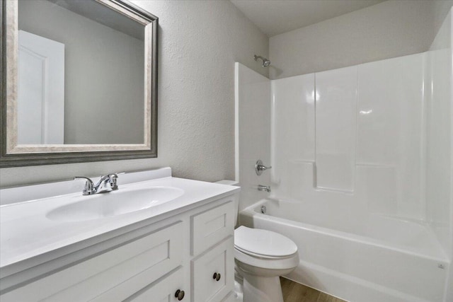 full bathroom featuring hardwood / wood-style flooring, shower / bathtub combination, toilet, and vanity