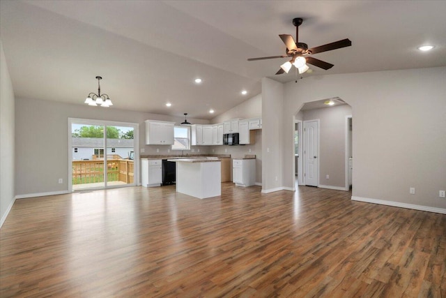 unfurnished living room with wood-type flooring, ceiling fan with notable chandelier, and lofted ceiling