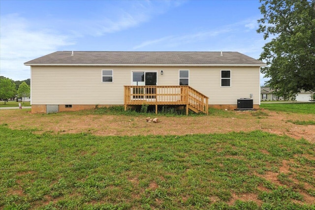 rear view of property with central AC, a deck, and a lawn