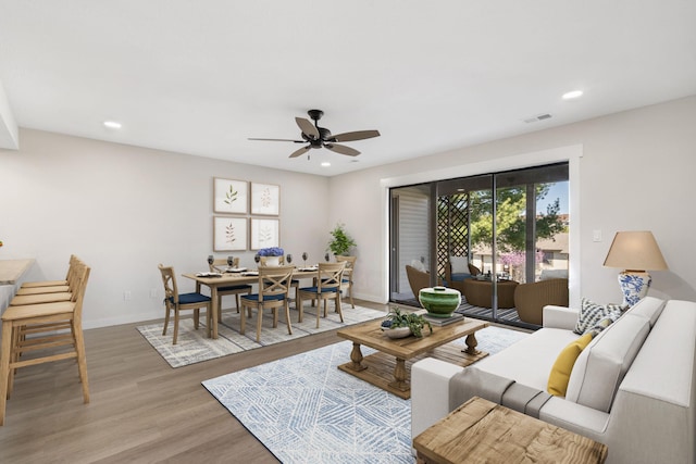 living room with hardwood / wood-style flooring and ceiling fan