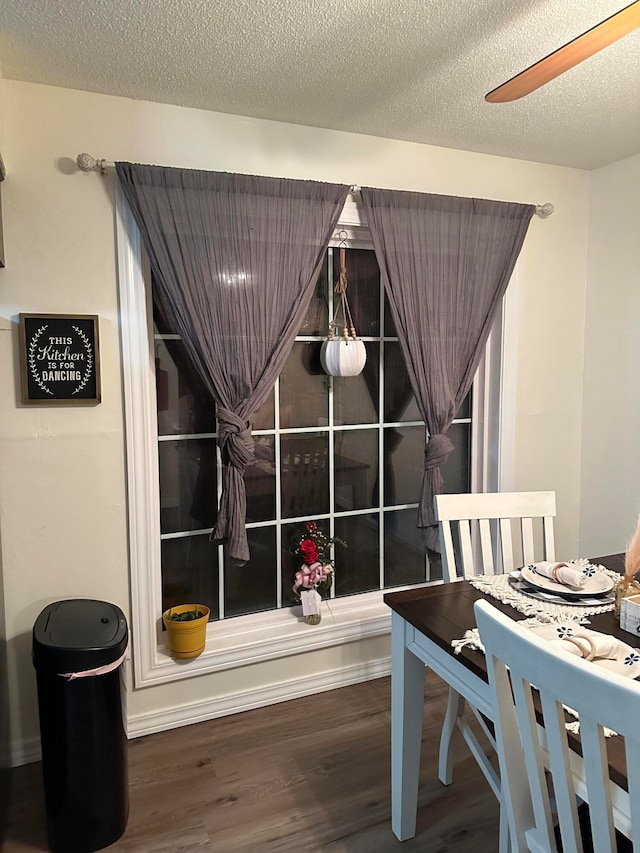 dining area with ceiling fan, hardwood / wood-style floors, and a textured ceiling