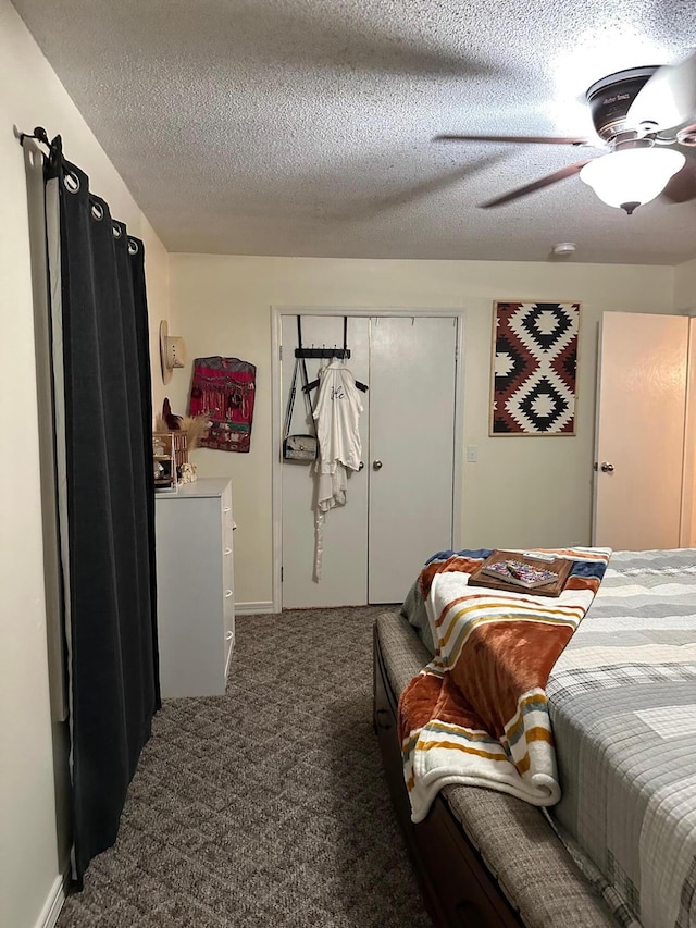 bedroom featuring ceiling fan, a textured ceiling, a closet, and dark colored carpet