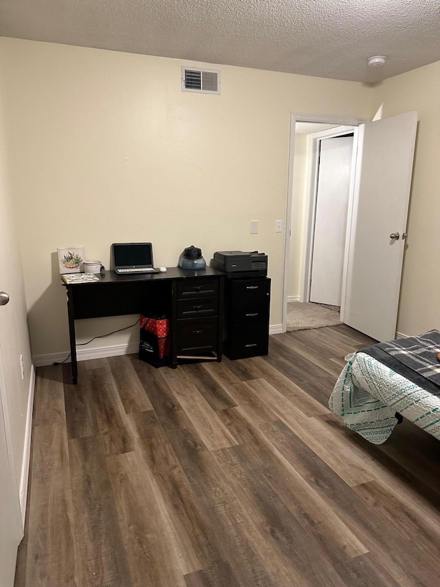 office space featuring a textured ceiling and dark hardwood / wood-style floors