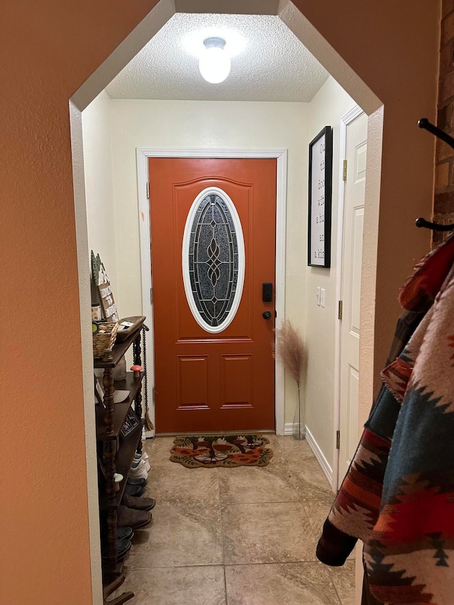 foyer entrance with a textured ceiling