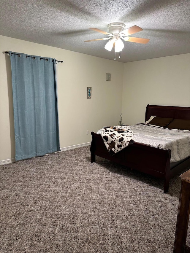 carpeted bedroom with ceiling fan and a textured ceiling