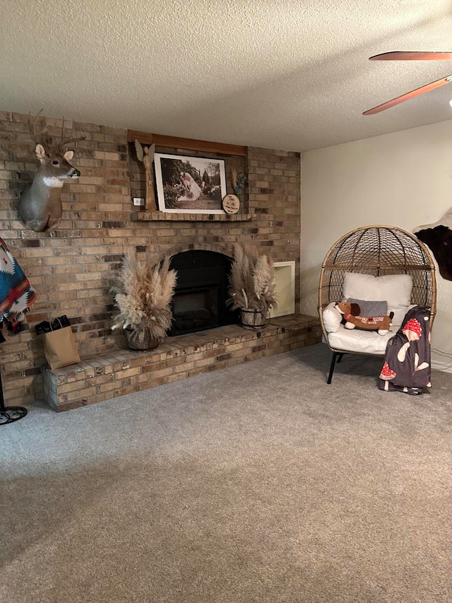 unfurnished living room featuring a brick fireplace, a textured ceiling, carpet, and ceiling fan