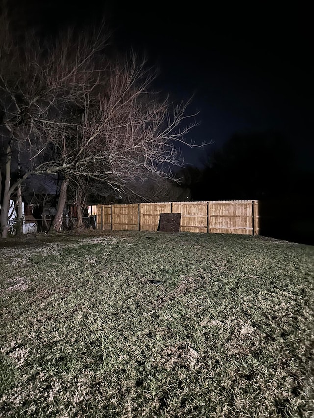 view of yard at twilight