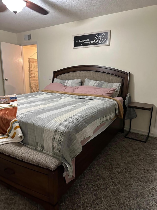 carpeted bedroom featuring a textured ceiling and ceiling fan