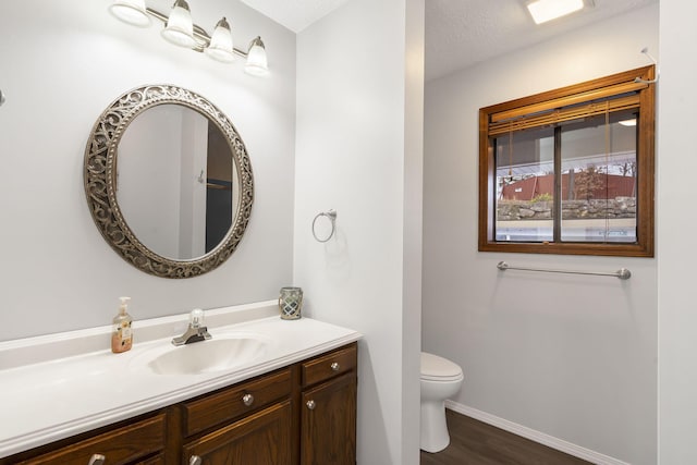 3 Port Holiday Dr Unit G, Kimberling City, MO 65686 - bathroom featuring wood finished floors, baseboards, vanity, and toilet