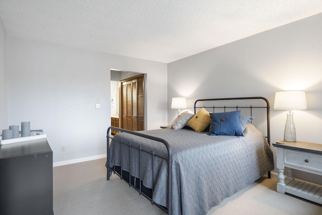 bedroom featuring a textured ceiling and carpet