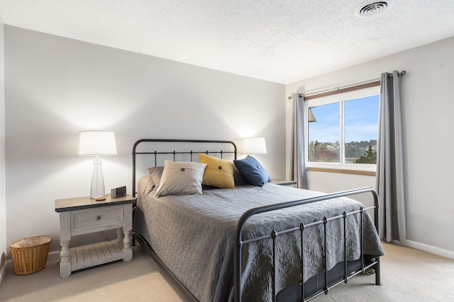 bedroom with carpet flooring and a textured ceiling