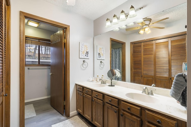 3 Port Holiday Dr Unit G, Kimberling City, MO 65686 - full bath featuring a ceiling fan, wood finished floors, a sink, and a textured ceiling
