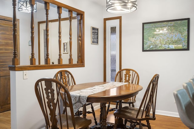 dining space with a notable chandelier and hardwood / wood-style flooring