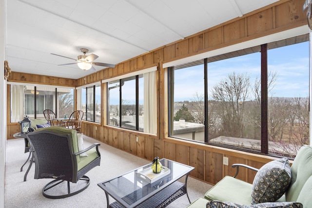 sunroom featuring ceiling fan