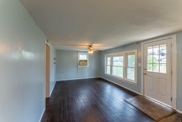 entrance foyer featuring ceiling fan, cooling unit, a textured ceiling, and dark hardwood / wood-style flooring