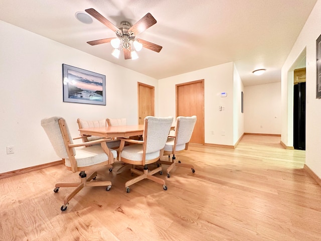 dining area with ceiling fan and light hardwood / wood-style floors