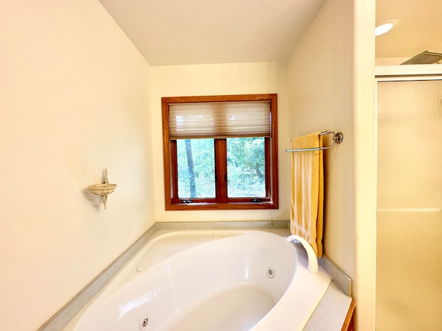 bathroom featuring separate shower and tub