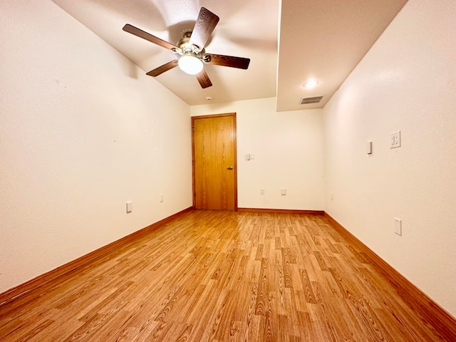 spare room with ceiling fan, light hardwood / wood-style flooring, and lofted ceiling