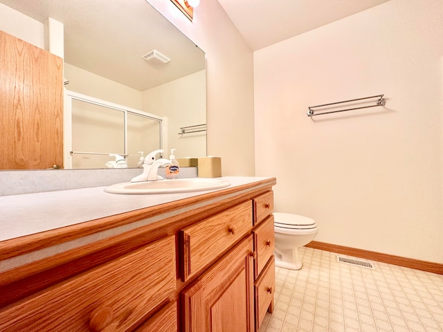 bathroom featuring walk in shower, vanity, and toilet