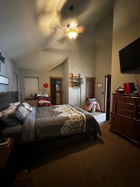 bedroom featuring lofted ceiling, ceiling fan, and light colored carpet