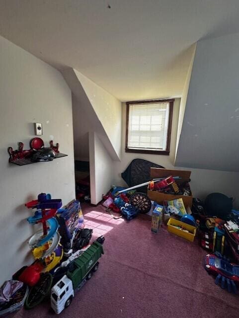 playroom with lofted ceiling and carpet