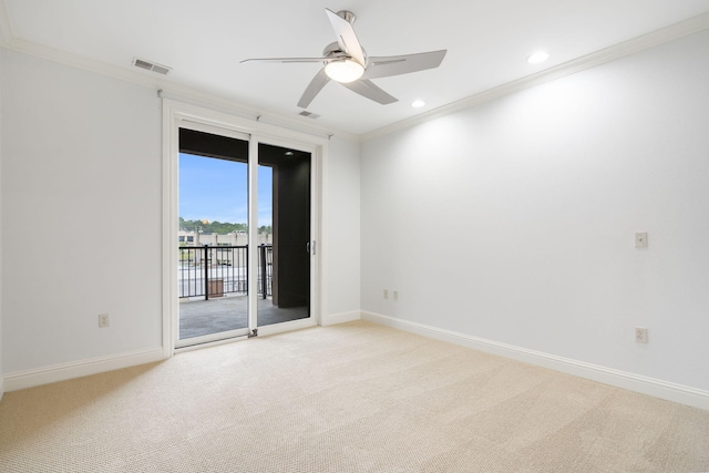 carpeted empty room with crown molding and ceiling fan