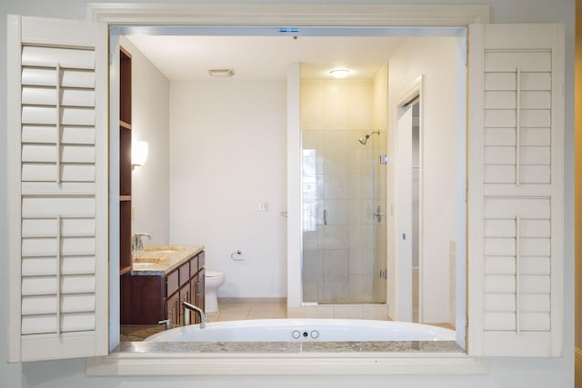 full bathroom with vanity, shower with separate bathtub, and toilet