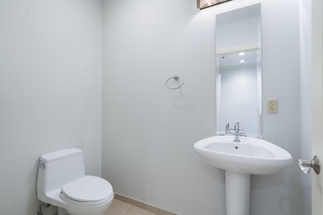 bathroom with toilet and tile patterned floors