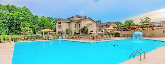community pool featuring a patio area and fence