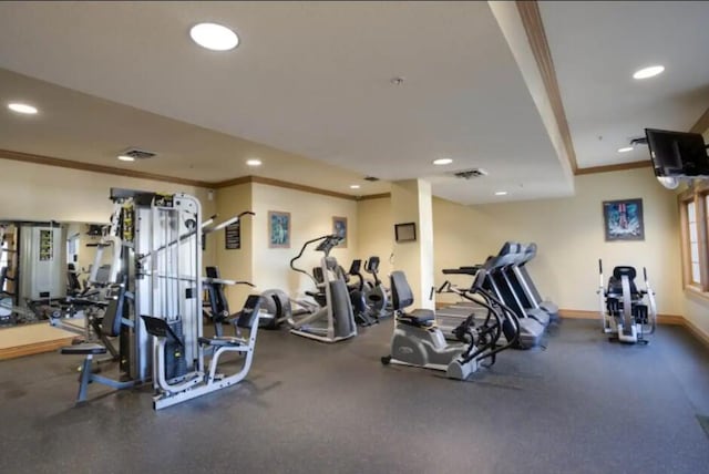 workout area featuring visible vents, baseboards, recessed lighting, and ornamental molding