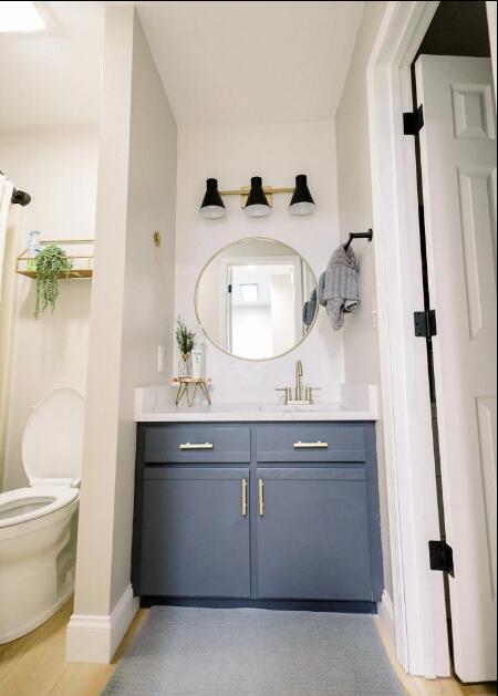 bathroom with baseboards, toilet, and vanity