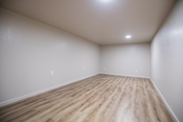 empty room with light hardwood / wood-style flooring