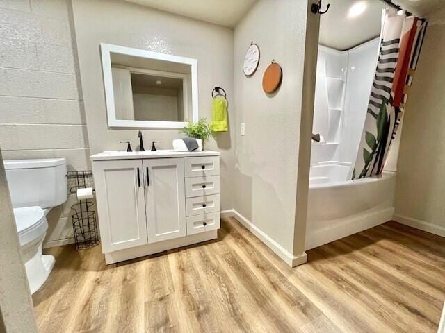 full bathroom featuring vanity, shower / tub combo with curtain, toilet, and wood-type flooring