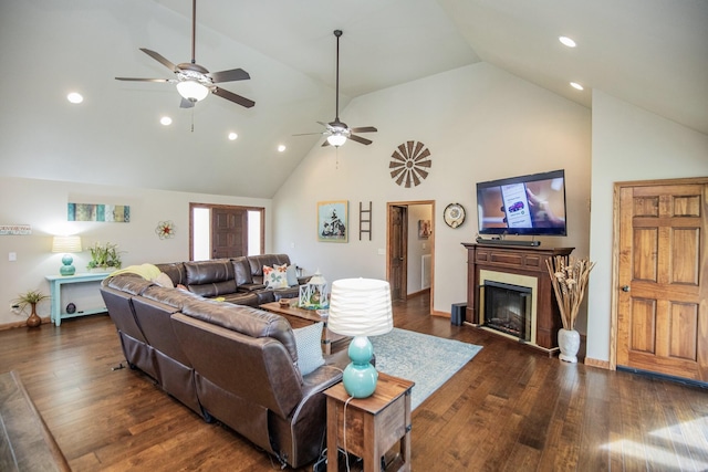 living room with ceiling fan, dark hardwood / wood-style floors, and high vaulted ceiling