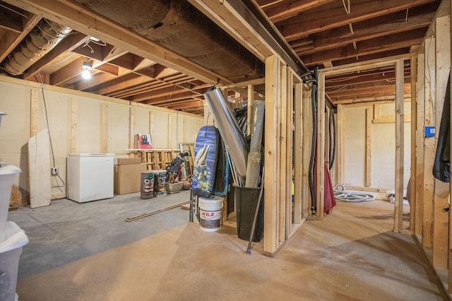 basement featuring white fridge