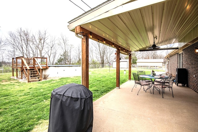 view of patio with a wooden deck, ceiling fan, and grilling area