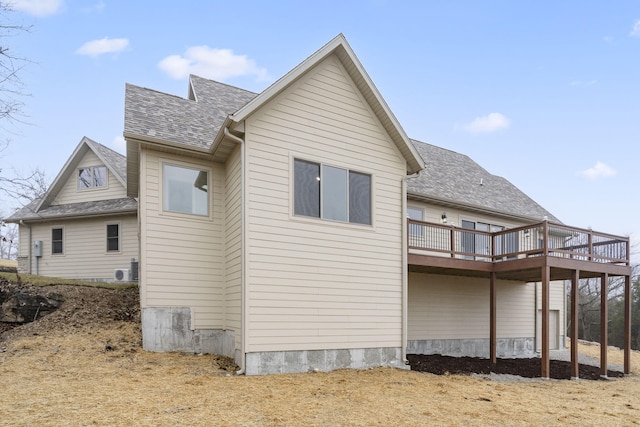 rear view of house featuring a wooden deck