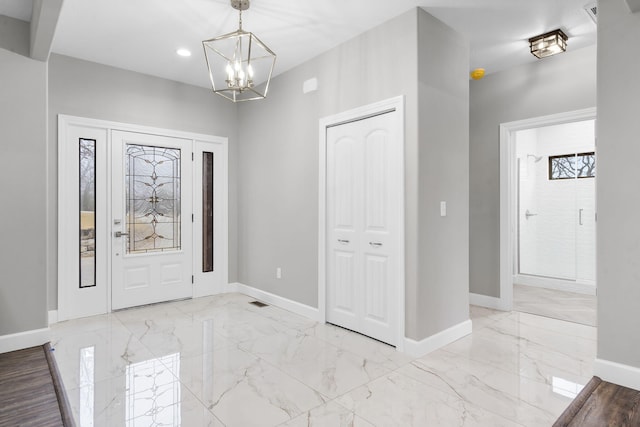 entrance foyer featuring an inviting chandelier