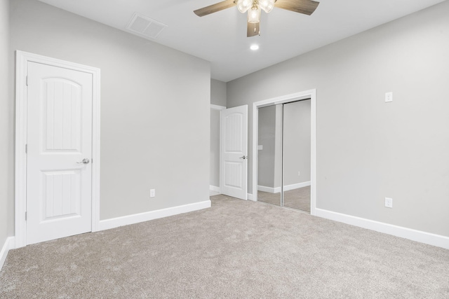 unfurnished bedroom with ceiling fan, carpet flooring, and a closet