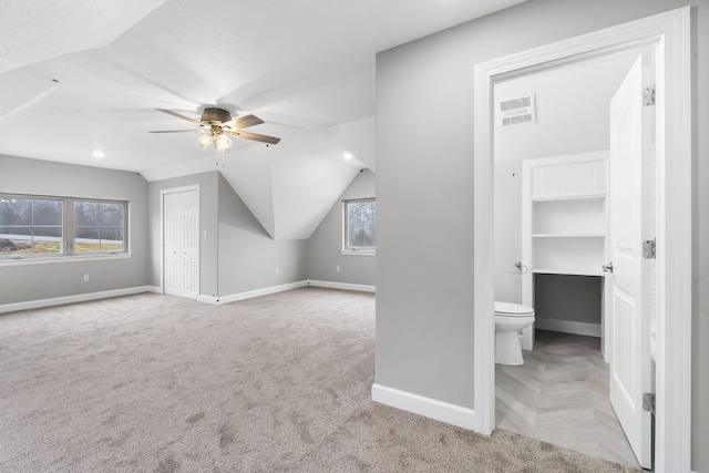 bonus room featuring ceiling fan, light colored carpet, and vaulted ceiling