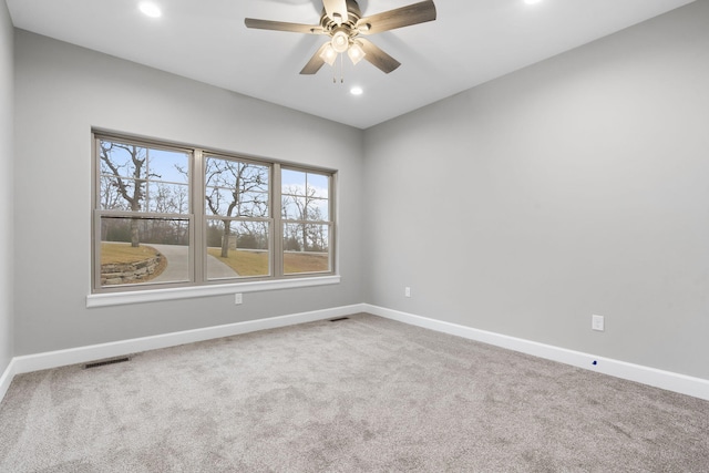 spare room with ceiling fan and carpet floors