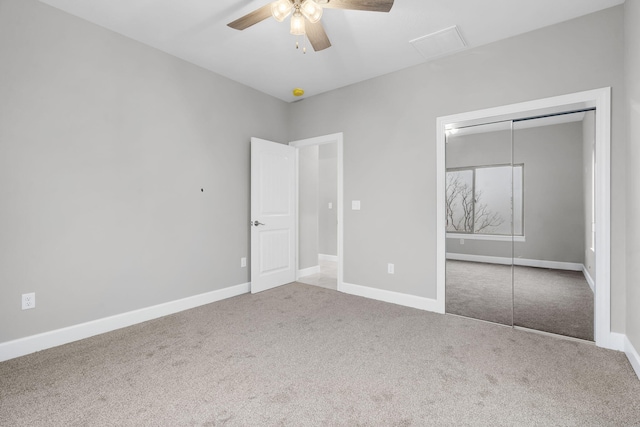 unfurnished bedroom featuring carpet floors, a closet, and ceiling fan