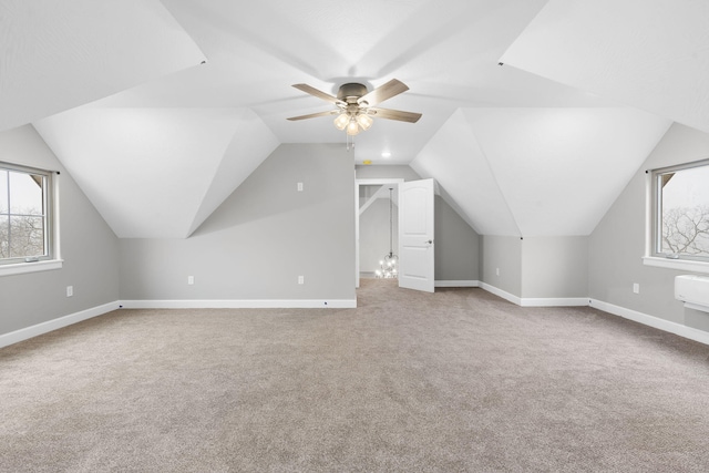 bonus room with vaulted ceiling, ceiling fan, carpet floors, and an AC wall unit