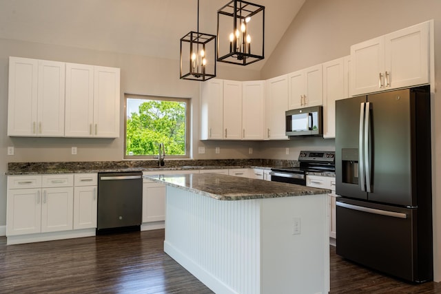 653 Forest Lake Dr, Branson West, MO 65737 - kitchen featuring appliances with stainless steel finishes, white cabinetry, dark wood-style flooring, dark stone counters, and a chandelier