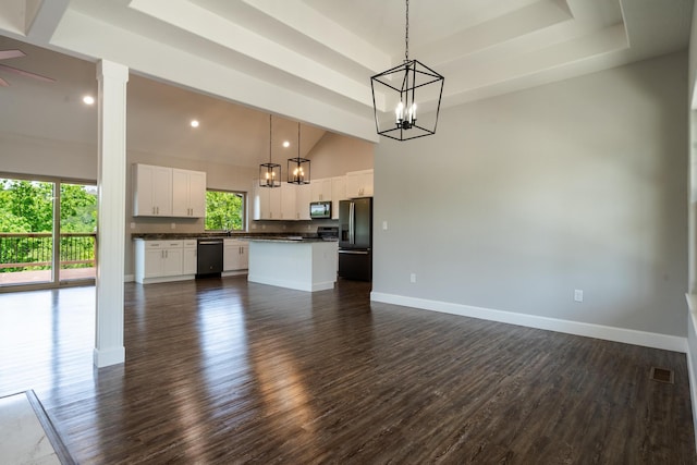 653 Forest Lake Dr, Branson West, MO 65737 - unfurnished living room with dark wood-style floors, a chandelier, a raised ceiling, baseboards, and high vaulted ceiling