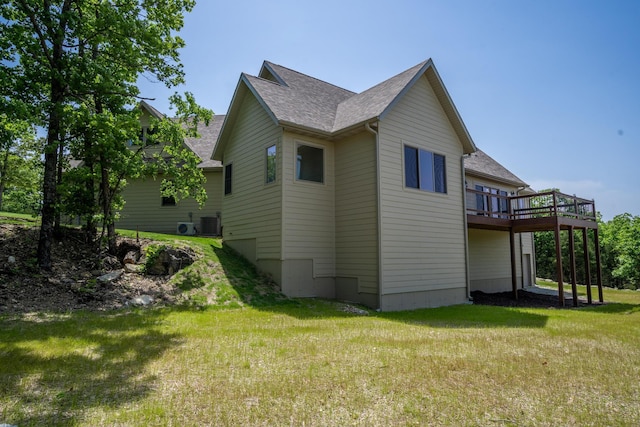 653 Forest Lake Dr, Branson West, MO 65737 - view of side of home featuring roof with shingles, a wooden deck, a yard, and central AC