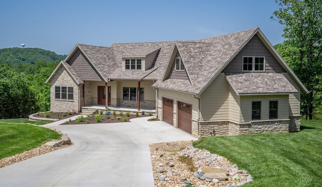 653 Forest Lake Dr, Branson West, MO 65737 - craftsman inspired home featuring stone siding, concrete driveway, a front lawn, a porch, and a garage