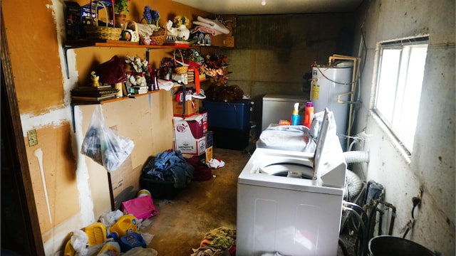 clothes washing area with washing machine and dryer and water heater